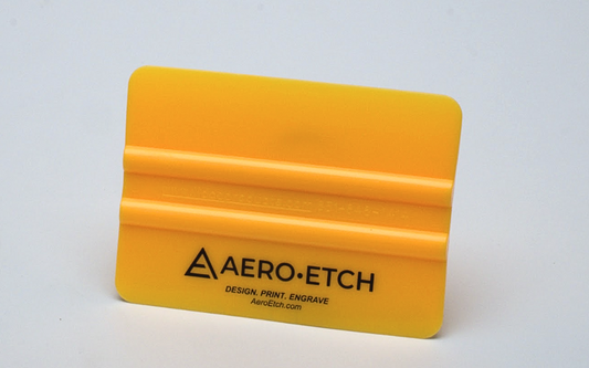 Yellow squeegee with 'Aero-Etch' branding